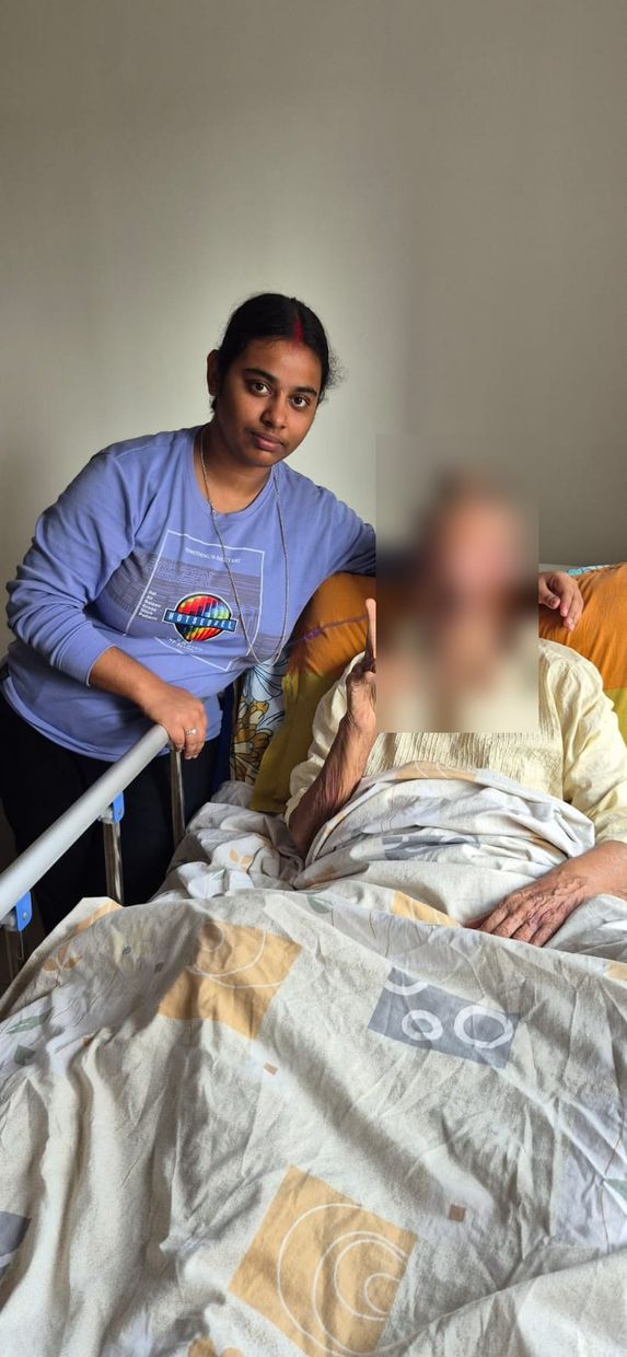 Varolyn caregiver sitting beside a patient resting at home