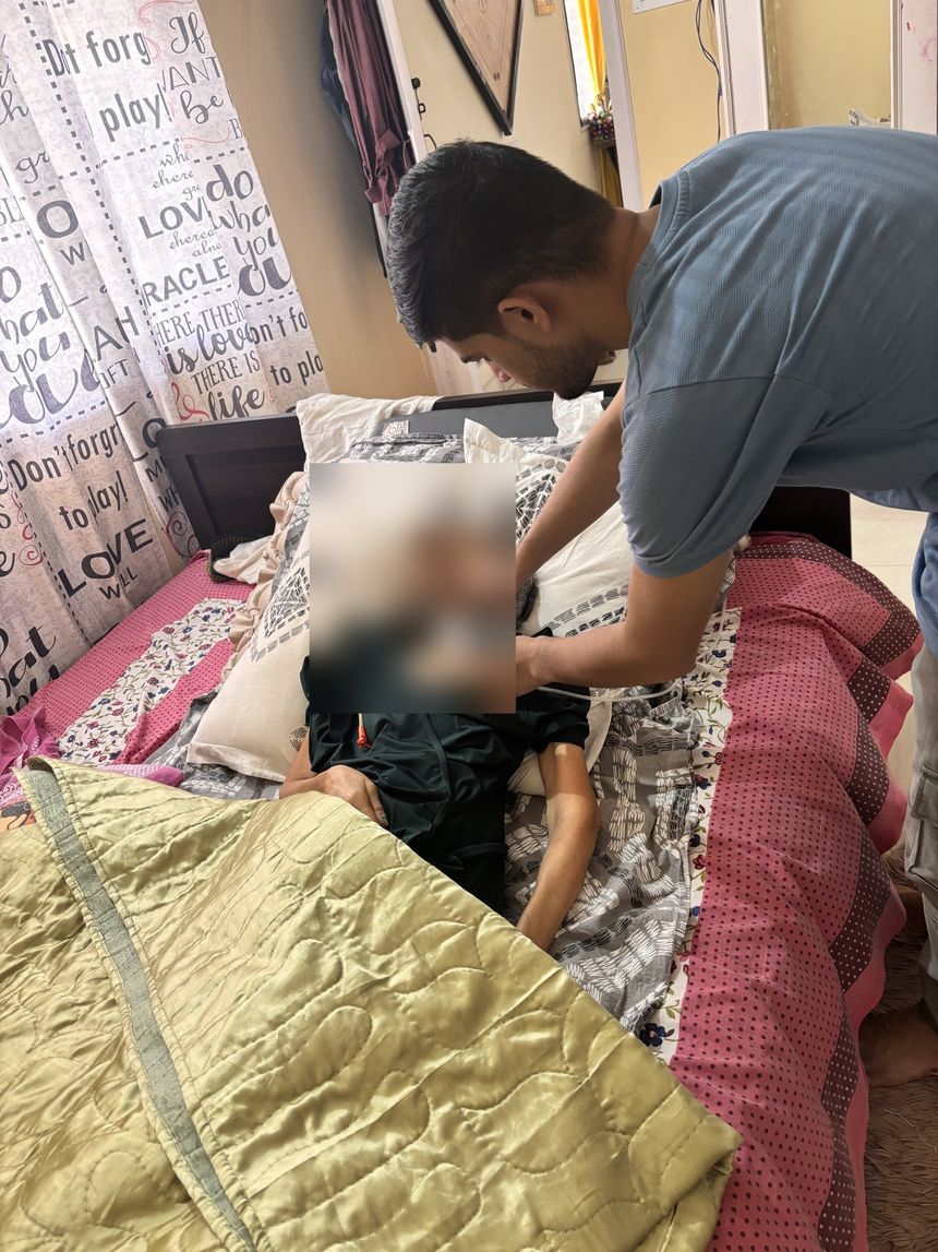 Varolyn caregiver gently attending a patient at home
