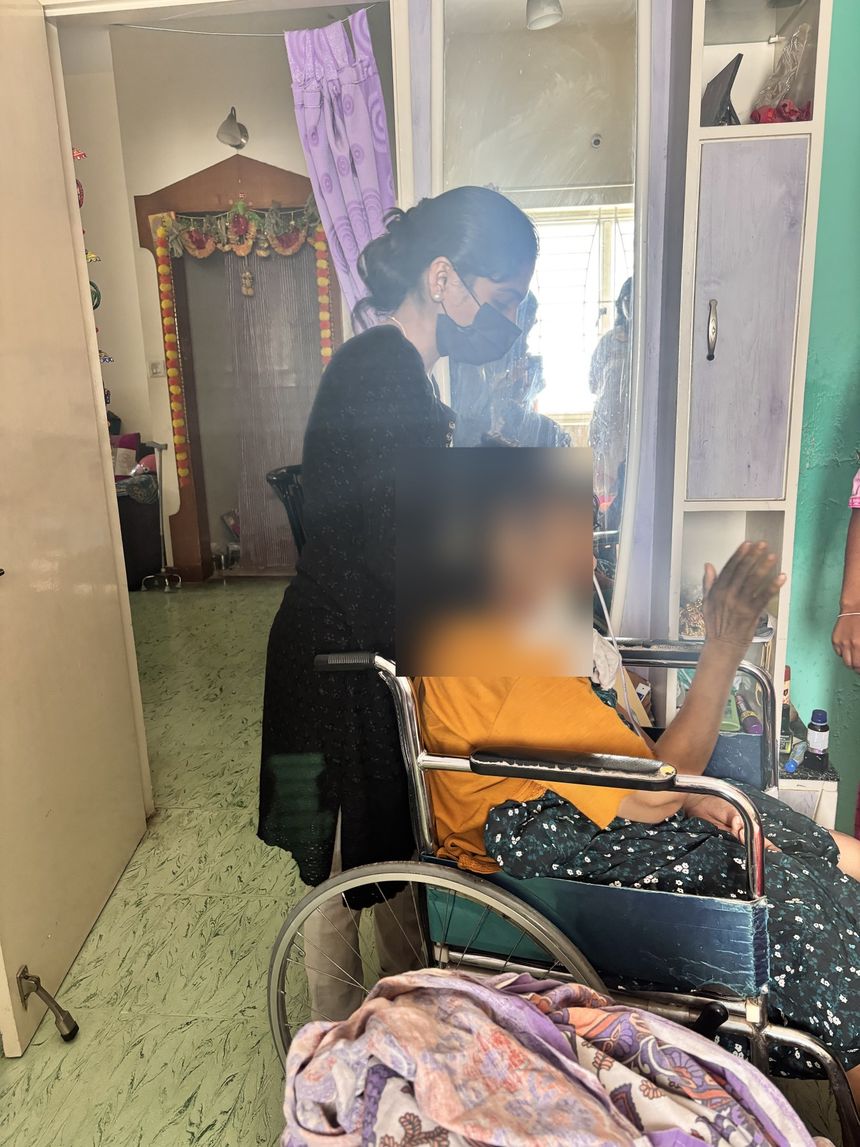 Varolyn caregiver assisting a patient in her wheelchair at home