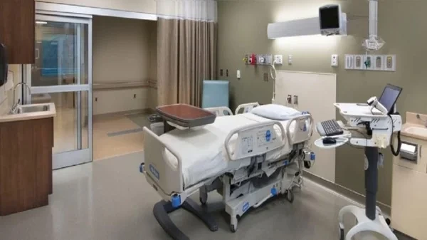 A warm, inviting healthcare facility with the Varolyn Healthcare logo prominently displayed. In the foreground, a smiling patient conversing with a compassionate nurse, their body language exuding care and trust. The middle ground showcases a cozy, well-equipped examination room, with state-of-the-art medical equipment and soothing decor. The background depicts a serene, natural landscape visible through large windows, creating a calming atmosphere. The lighting is soft and diffused, lending an air of comfort and tranquility. The entire scene conveys Varolyn Healthcare's commitment to patient-centered care, where the well-being and comfort of individuals are the top priorities. ICU service at home
